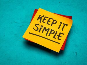 A sticky note with the words written, keep it simple